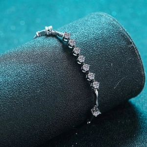 Elegant 925 sterling silver bracelet with sparkling round moissanite stones on black display