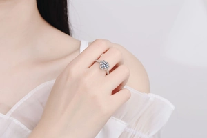Close-up of S925 silver heart ring with sparkling round moissanite on model hand