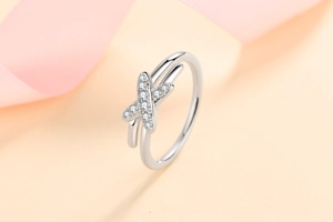 Close-up of S925 sterling silver criss cross ring with sparkling moissanite stones