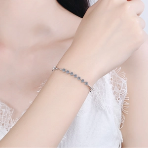 Minimalist 925 sterling silver bracelet with nine sparkling moissanite stones on wrist