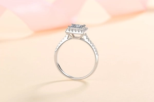 Macro shot of princess cut moissanite engagement ring in sterling silver with halo