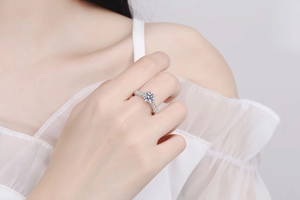 Macro detail of a 925 sterling silver ring featuring a sparkling moissanite flower setting