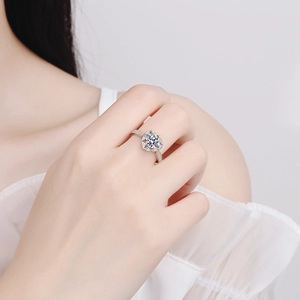 Elegant heart-shaped halo moissanite engagement ring with pave diamond band on finger