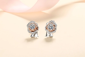 Detailed close-up of rose flower earrings featuring moissanite stones in silver and rose gold