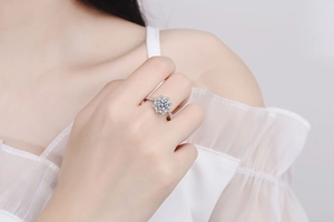 Close-up of S925 silver ring with flower design and sparkling moissanite stone