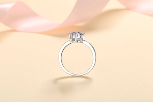 Detail of a minimalist S925 silver ring featuring a six-prong round purple moissanite stone