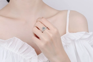 Close-up of elegant V-shaped S925 silver ring with Moissanite stone on model's finger