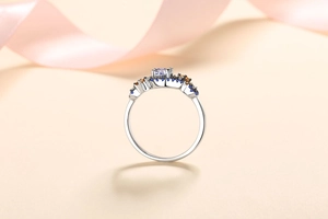 Detailed view of silver ring featuring square-cut moissanite and colorful side stones