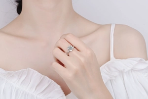 Detail shot of the silver flower-shaped ring with a brilliant round moissanite center stone