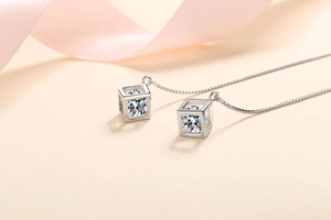Detailed view of S925 silver cube earrings with tassel chain and brilliant moissanite stone