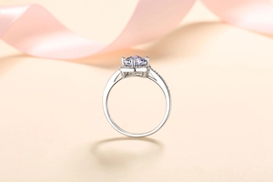 Close-up of S925 silver moissanite ring with purple gemstone and silk ribbon decoration