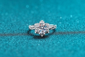 Macro detail of snowflake moissanite ring with wavy diamond-encrusted band in S925 silver