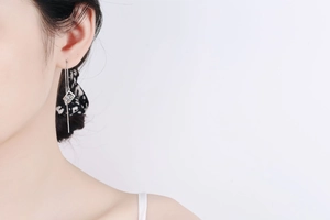 Close-up of S925 silver threader earrings with geometric square moissanite tassel pendant
