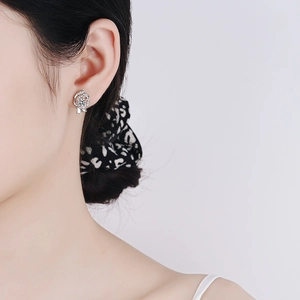 Elegant S925 sterling silver rose earrings with moissanite stones on female model