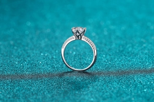 Detail of a 925 silver ring with classic four-prong setting and round sparkling diamond