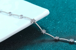 Macro shot of silver star bracelet featuring round moissanite stones and pavé detailing