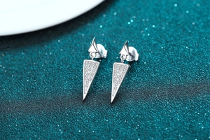 Macro view of S925 sterling silver long triangle earrings with full pavé moissanite inlay