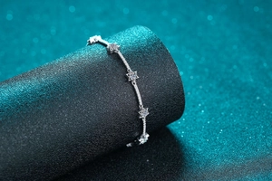 Macro detail of 925 sterling silver star bracelet with shimmering moissanite star charms