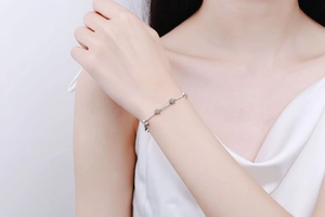 Detailed view of sterling silver star bracelet with shimmering moissanite diamonds on wrist