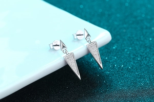Macro shot of S925 sterling silver long triangle earrings featuring pavé moissanite stones