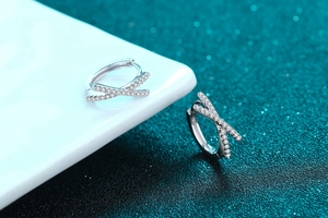 Macro shot of S925 sterling silver X-shaped earrings with shimmering pavé moissanite stones