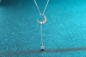 Macro shot of S925 silver crescent moon and star pendant with sparkling pavé stones
