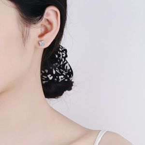 Square cut S925 sterling silver stud earrings with moissanite on a female model