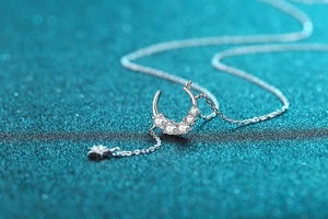 Macro shot of S925 sterling silver crescent moon necklace with sparkling zircon stars