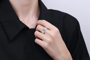 Close-up of men's square-cut moissanite ring with textured geometric silver band