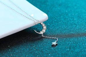 Close-up of S925 silver crescent moon and star pendant necklace with cubic zirconia