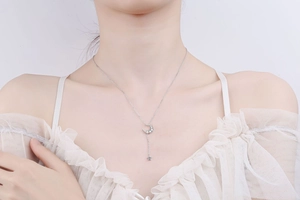 Detailed view of S925 silver moon and star pendant necklace on a model's collarbone