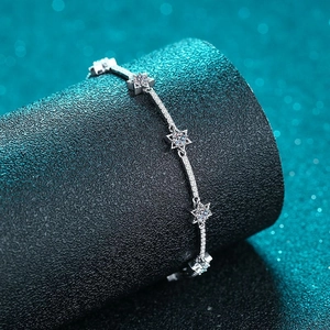 Elegant 925 sterling silver star bracelet with shimmering moissanite on a display stand