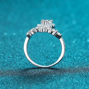 Sparkling S925 silver halo ring with heart-shaped moissanite on blue glitter background
