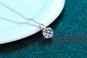 Macro shot of 925 silver moissanite necklace with classic round brilliant cut pendant