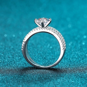 925 silver moissanite engagement ring with four-prong setting and pavé diamond band