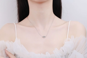 Detailed view of S925 sterling silver evil eye pendant necklace on a female neck