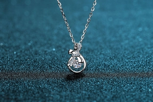 Macro shot of S925 silver necklace featuring a dancing moissanite stone in a bow pendant