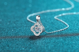 Macro view of clover-shaped S925 silver pendant with sparkling moissanite stones