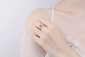 Detail of S925 sterling silver crown ring with moissanite on a model's hand