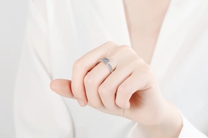 Elegant silver Moissanite ring on finger showing flower-shaped diamond cluster and pavé setting