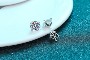 Macro view of sterling silver moissanite stud earrings with heart-shaped backs