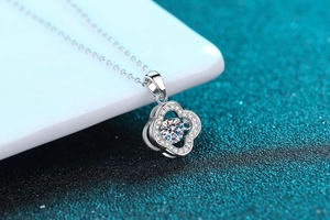 Macro view of S925 silver clover pendant with central round moissanite and pave setting