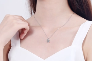 Detail shot of a S925 sterling silver necklace with a dancing moissanite stone pendant