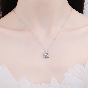 Square silver necklace with pink halo moissanite pendant worn by a model