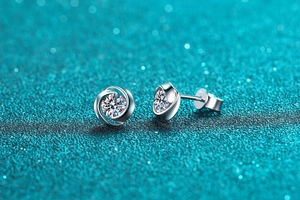 Macro shot of S925 sterling silver cyclone earrings with moissanite bezel setting