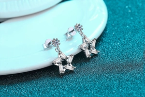 Macro shot of S925 sterling silver star stud earrings with sparkling baguette zircon