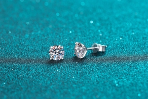 Close-up of sparkling moissanite stud earrings with classic four-prong silver setting