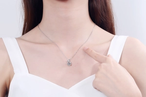 Close-up of S925 sterling silver necklace with a sparkling dancing moissanite pendant