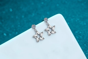 Macro shot of S925 silver star earrings with baguette-cut moissanite stones