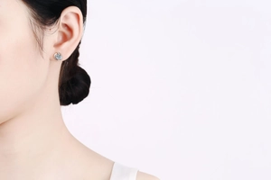 Close-up of S925 sterling silver moissanite stud earring on a model's ear